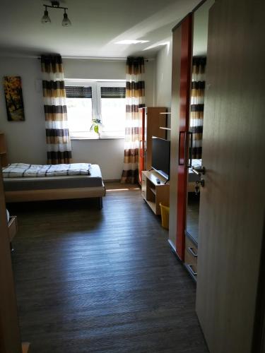a room with a bed and a tv in it at Wohnung 13 in Wildeshausen