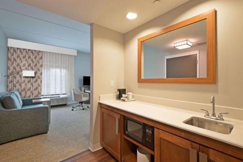 a bathroom with a sink and a mirror at Hampton Inn & Suites North Huntingdon-Irwin, PA in Irwin