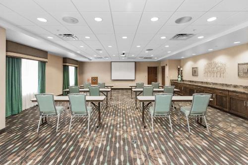 a conference room with tables and chairs and a screen at Hampton Inn Bridgeville in Bridgeville