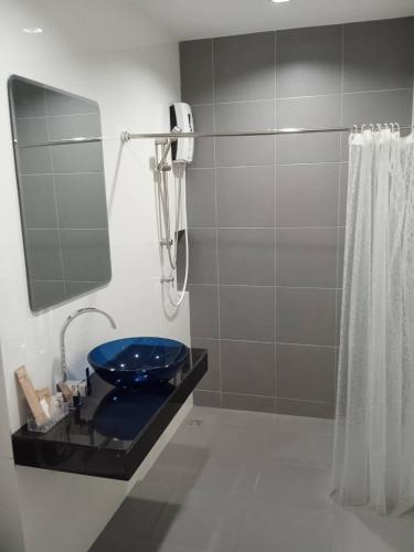 a bathroom with a blue toilet and a shower at D Night Suite Hotel in Bangkok