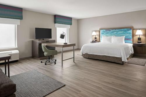 a hotel room with a bed and a desk with a computer at Hampton Inn & Suites Cranberry Township/Mars in Cranberry Township