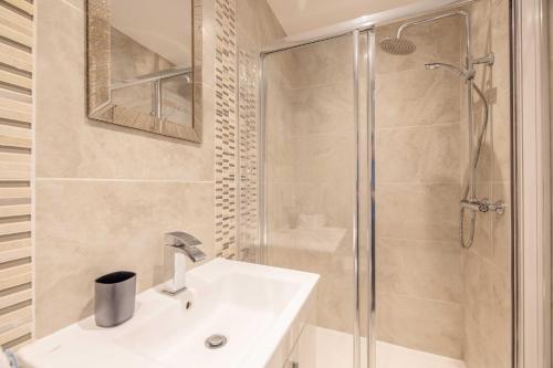 a bathroom with a white sink and a shower at Spacious 4 Bed - Near Uxbridge/Heathrow & PARKING in Slough