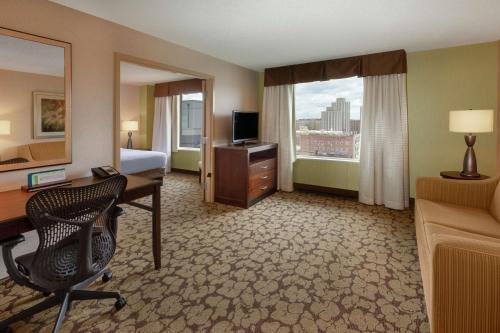 a hotel room with a bed and a desk with a computer at Hilton Garden Inn Pittsburgh University Place in Pittsburgh