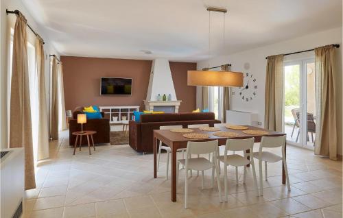 a kitchen and living room with a table and chairs at Villa 6 Mala Rudina in Rudina