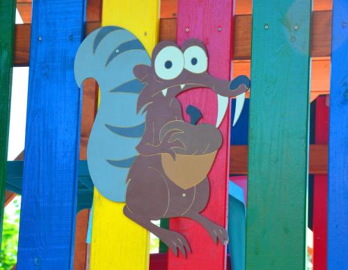 a painting of a monkey on a colorful fence at Villa Gold in Nová Lesná