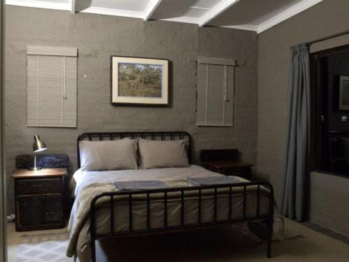 a bedroom with a bed and a picture on the wall at Horizon Savannah in Dinokeng Game Reserve