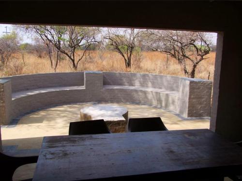a view of a table and chairs from a window at Horizon Savannah in Dinokeng Game Reserve