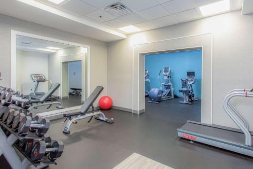 a gym with treadmills and cardio equipment and a mirror at Hampton Inn Pensacola Beach in Pensacola Beach