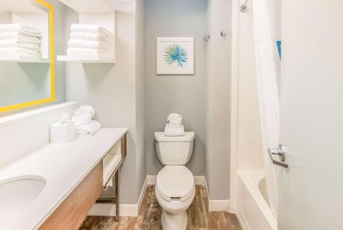 a white bathroom with a toilet and a sink at Hampton Inn Pensacola Beach in Pensacola Beach