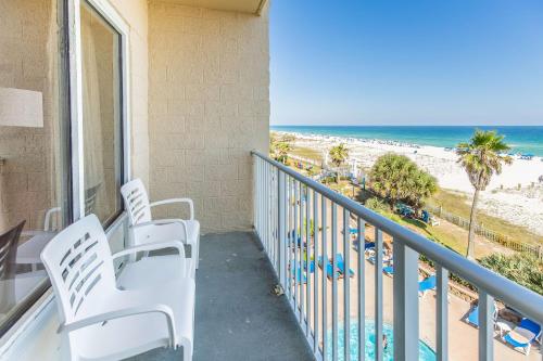 a balcony with chairs and a view of the beach at Hampton Inn Pensacola Beach in Pensacola Beach
