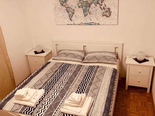 a bedroom with a bed with two towels on it at Hiška on the cliff in Ankaran
