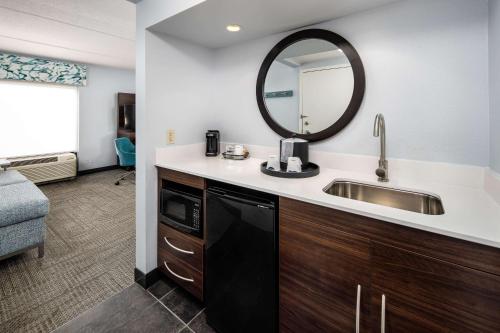 a bathroom with a sink and a mirror at Hampton Inn & Suites Navarre in Navarre