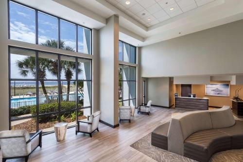 an office lobby with a view of a pool at The Island House Hotel a Doubletree by Hilton in Orange Beach