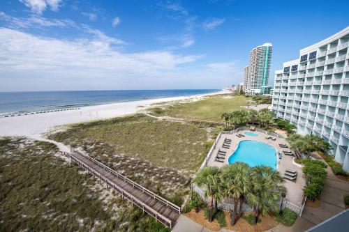 an aerial view of a hotel and the beach at The Island House Hotel a Doubletree by Hilton in Orange Beach