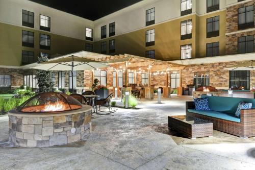 an outdoor patio with a fire pit in front of a building at Homewood Suites By Hilton Poughkeepsie in Poughkeepsie