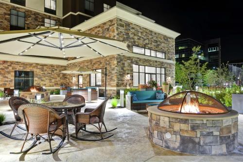a patio with a fire pit and a table and chairs at Homewood Suites By Hilton Poughkeepsie in Poughkeepsie