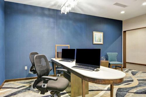 an office with two computers on a table with chairs at Homewood Suites By Hilton Poughkeepsie in Poughkeepsie
