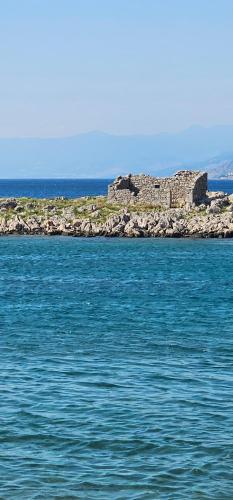 an island in the middle of a body of water at Apartments Klara in Sveti Juraj