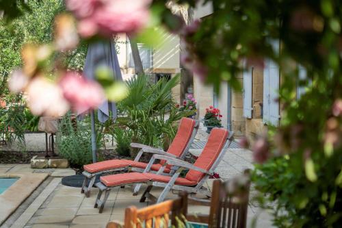 a couple of chairs sitting next to a pool at B&B Le Clos d'Argenson in Bergerac