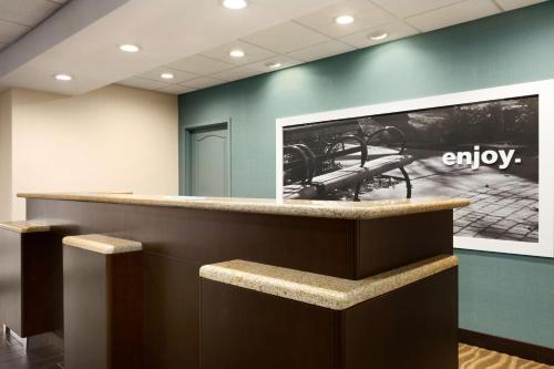 an empty lobby with a large picture on the wall at Hampton Inn Dover in Dover
