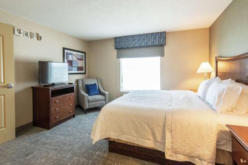 um quarto de hotel com uma cama e uma televisão em Hampton Inn Presque Isle em Presque Isle