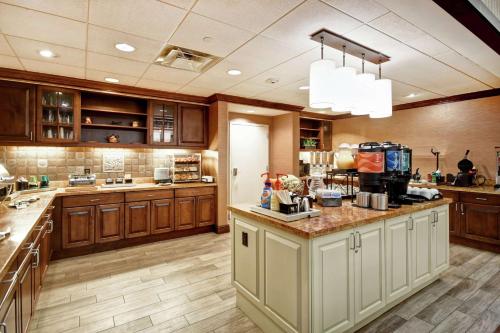 a large kitchen with wooden cabinets and a counter top at Homewood Suites by Hilton Dover in Dover