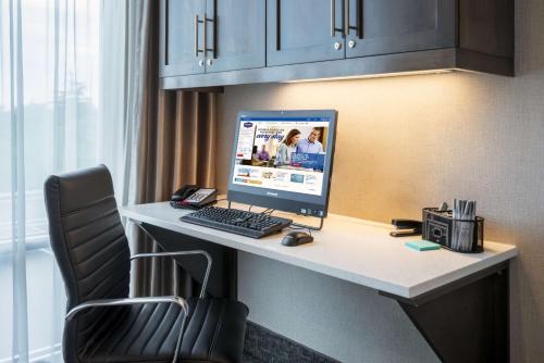 a desk with a computer on it in a hotel room at Hampton Inn by Hilton Oxford, ME in Oxford