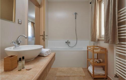 a bathroom with a white tub and a sink at Villa 5 Mala Rudina in Rudina