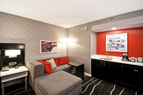 a small living room with a couch and a sink at DoubleTree by Hilton Deadwood at Cadillac Jack's in Deadwood