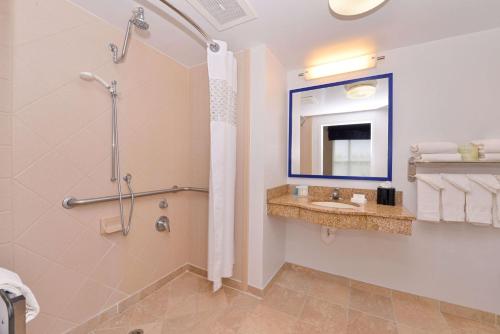 a bathroom with a shower and a sink at Hampton Inn & Suites by Hilton Plymouth in Plymouth