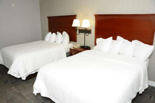 two beds in a hotel room with white sheets at Hampton Inn & Suites Redding in Redding