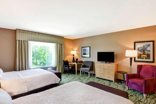 ein Hotelzimmer mit 2 Betten und einem Schreibtisch in der Unterkunft Hampton Inn & Suites Crabtree in Raleigh