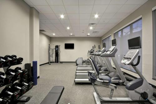 a gym with rows of treadmills and machines at Homewood Suites by Hilton Raleigh Cary I-40 in Cary