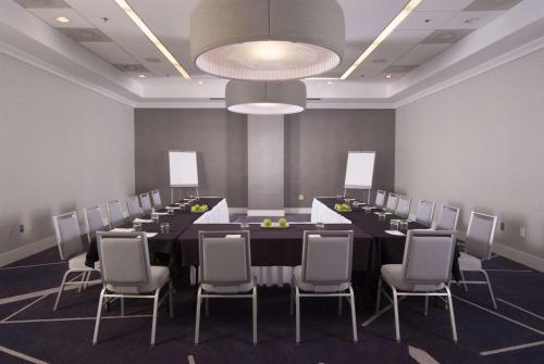 a conference room with a long table and chairs at Embassy Suites by Hilton Raleigh Crabtree in Raleigh