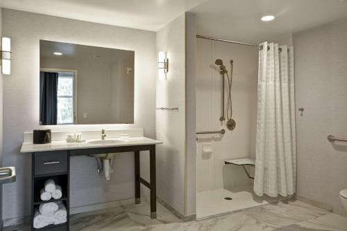 a bathroom with a sink and a shower at Homewood Suites by Hilton Raleigh Cary I-40 in Cary