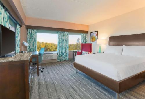 a hotel room with a bed and a desk at Hilton Garden Inn Raleigh-Durham/Research Triangle Park in Durham