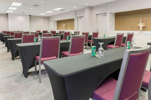 a conference room with tables and purple chairs at Hilton Garden Inn Raleigh-Durham/Research Triangle Park in Durham
