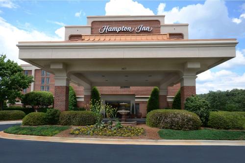a building with a sign on top of it at Hampton Inn Raleigh Capital Blvd North in Raleigh