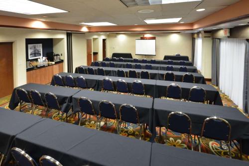 a conference room with rows of chairs and a screen at Hampton Inn Raleigh Capital Blvd North in Raleigh