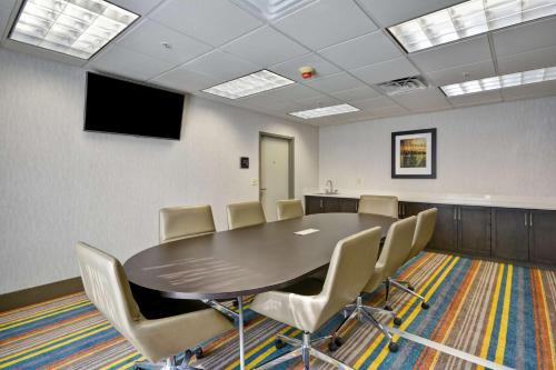 a conference room with a table and chairs at Homewood Suites Durham-Chapel Hill I-40 in Durham