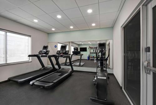 a gym with two tread machines in a room at Tru By Hilton Burlington in Burlington