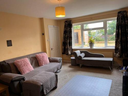 a living room with a couch and a chair at 2 bedroom house with lovely garden and views in Brighton & Hove