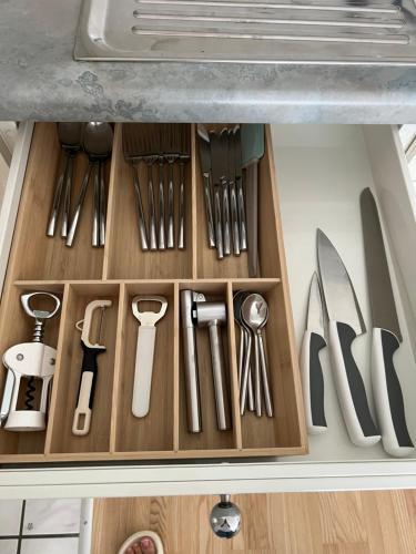 a drawer full of kitchen utensils in a cabinet at Black&White Apartment in Uzwil