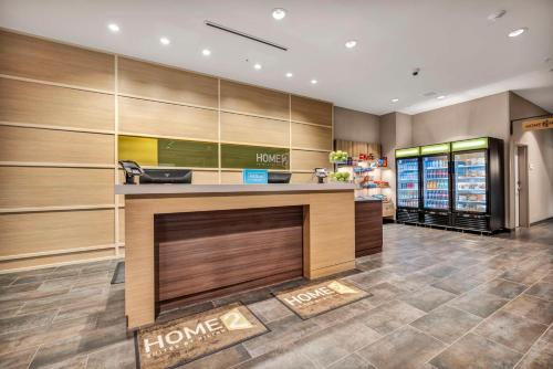 a store lobby with a h home counter at Home2 Suites by Hilton Raleigh West Lenovo Center in Raleigh