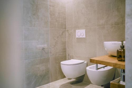 a bathroom with a toilet and a sink at Auszait Apartments 1 in Caldaro