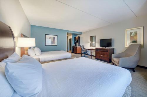 a hotel room with a large bed and a television at Hilton Garden Inn Durham Southpoint in Durham