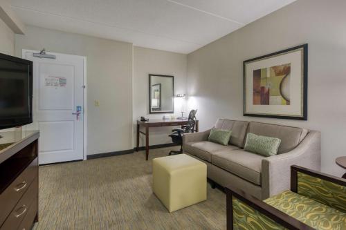 a living room with a couch and a flat screen tv at Hilton Garden Inn Durham Southpoint in Durham