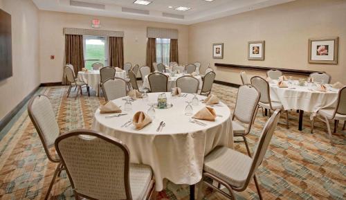 a banquet room with white tables and chairs at Hilton Garden Inn Durham Southpoint in Durham