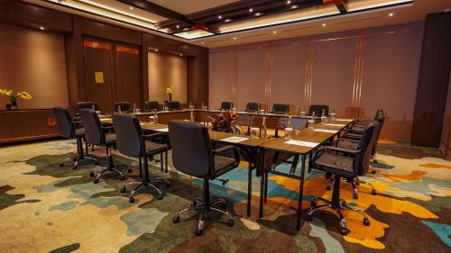 a conference room with a long table and chairs at FUGO Hotel Samarinda in Samarinda