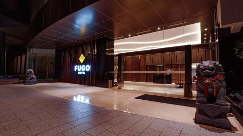 a lobby of a building with a sign on the wall at FUGO Hotel Samarinda in Samarinda